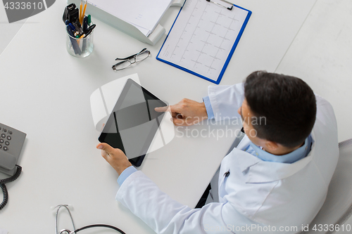Image of doctor with tablet pc and cardiogram at clinic
