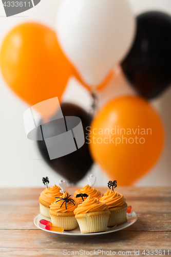 Image of halloween party decorated cupcakes on plate