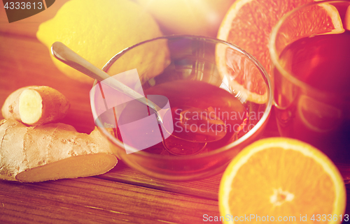 Image of tea with honey, lemon and ginger on wood