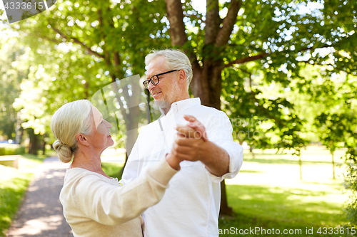 Image of happy senior couple dancing at summer city park