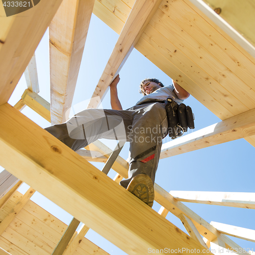Image of Builders at work with wooden roof construction.