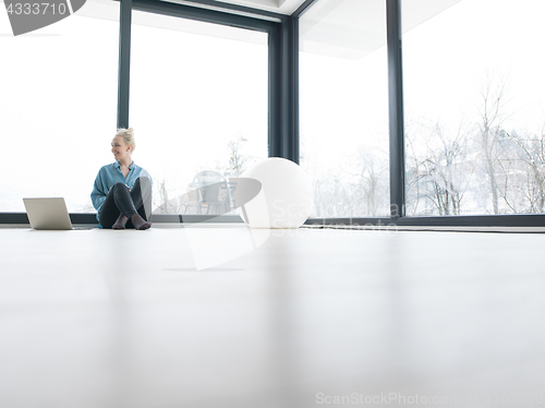 Image of young woman drinking coffee enjoying relaxing lifestyle