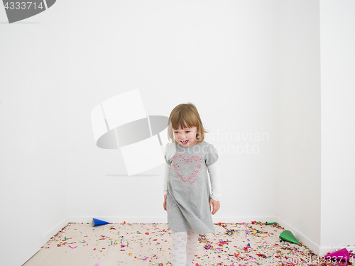 Image of Little girl standing on confetti