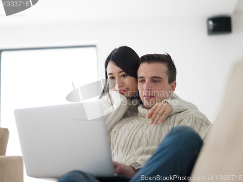 Image of multiethnic couple using laptop computers