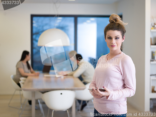 Image of Portrait of  smiling casual businesswoman using tablet  with cow