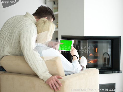 Image of Couple using digital tablet on cold winter day