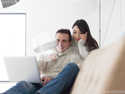 Image of multiethnic couple using laptop computers