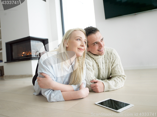 Image of Young Couple using digital tablet on cold winter day