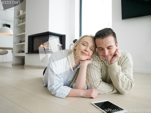 Image of Young Couple using digital tablet on cold winter day