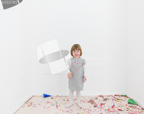 Image of Little girl standing on confetti