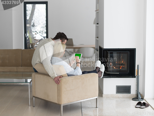 Image of Couple using digital tablet on cold winter day