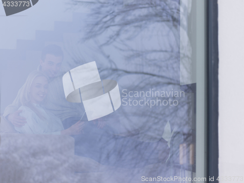 Image of Couple using digital tablet on cold winter day
