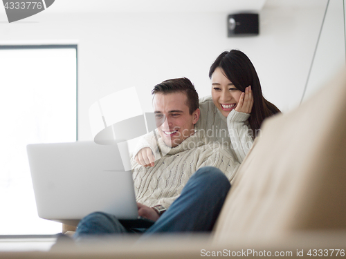 Image of multiethnic couple using laptop computers