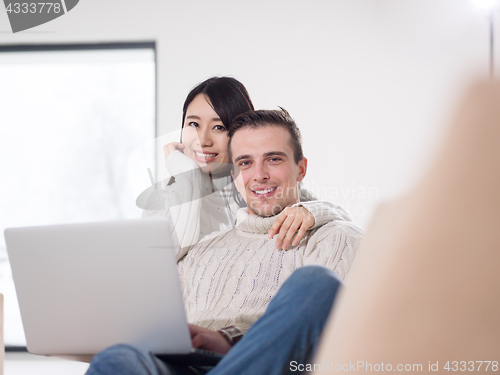 Image of multiethnic couple using laptop computers