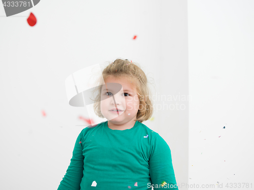 Image of kid blowing confetti