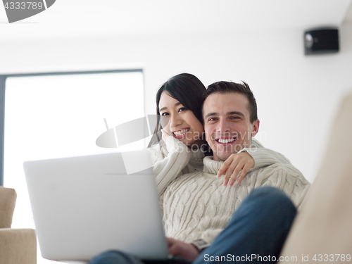 Image of multiethnic couple using laptop computers