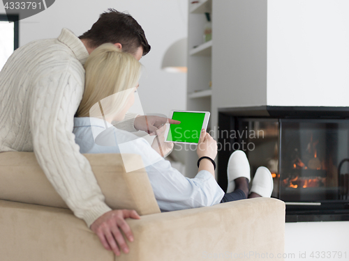 Image of Couple using digital tablet on cold winter day