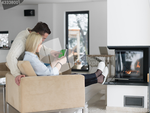 Image of Couple using digital tablet on cold winter day