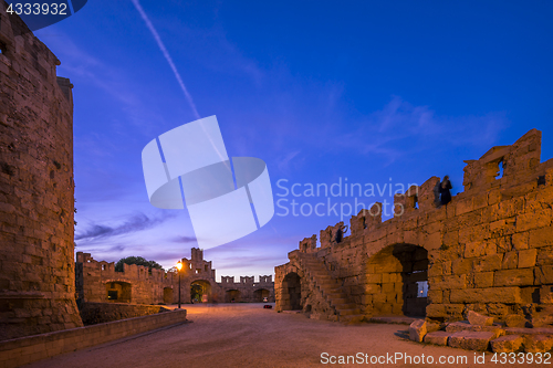 Image of The fortress wall in the harbor at sunset. Rhodes