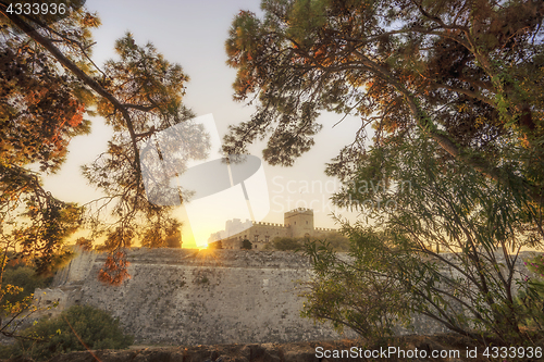 Image of The fortress wall in the harbor at sunset. Rhodes