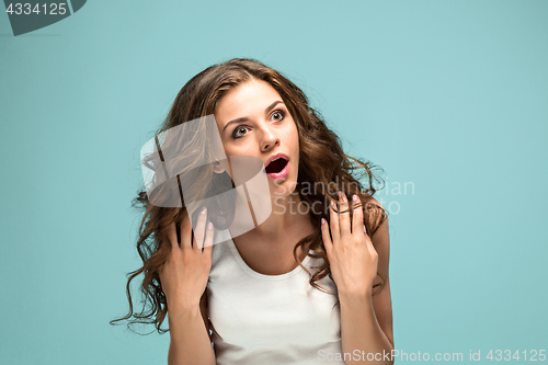 Image of Portrait of young woman with shocked facial expression