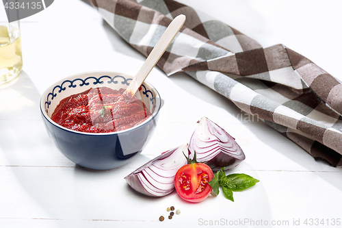 Image of Bowl of chopped tomatoes on rustic table