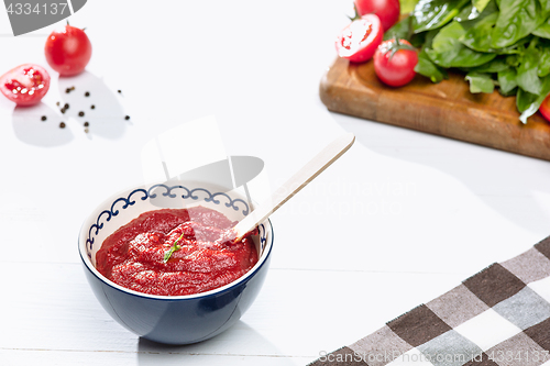 Image of Bowl of chopped tomatoes on rustic table