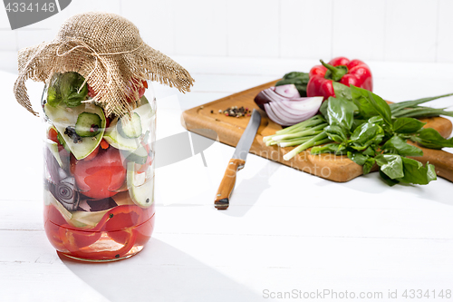 Image of Canned tomatoes and fresh tomato on white background