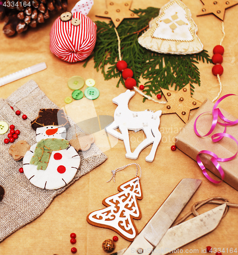Image of lot of stuff for handmade gifts, scissors, ribbon, paper with countryside pattern, ready for holiday concept, nobody home 