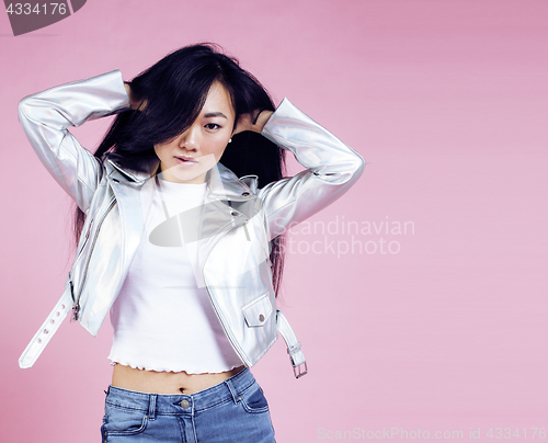 Image of young pretty smiling asian korean girl wearing modern fashion clothers on pink background, lifestyle people concept 