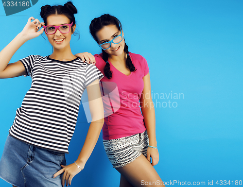 Image of best friends teenage school girls together having fun, posing emotional on blue background, besties happy smiling, lifestyle people concept 