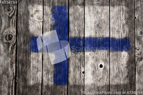 Image of finnish flag on aged wooden wound