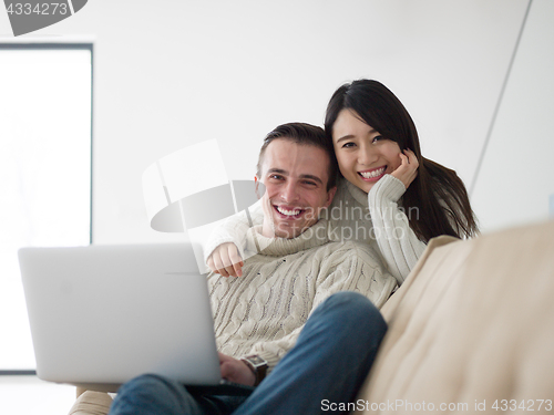 Image of multiethnic couple using laptop computers