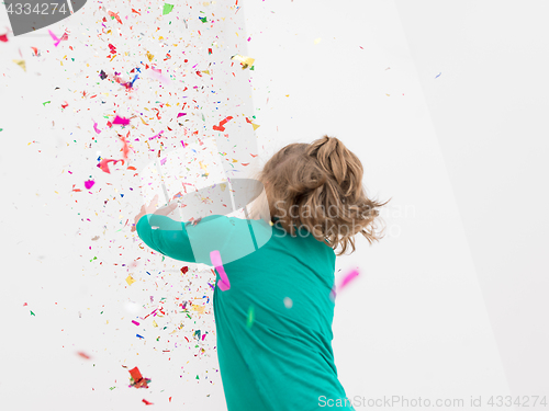 Image of kid blowing confetti