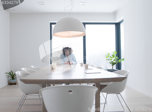 Image of man using a mobile phone  at home