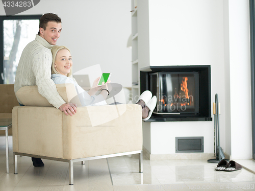 Image of Couple using digital tablet on cold winter day