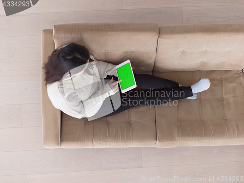 Image of top view of asian woman using Digital Tablet on sofa