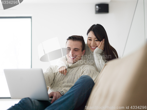 Image of multiethnic couple using laptop computers