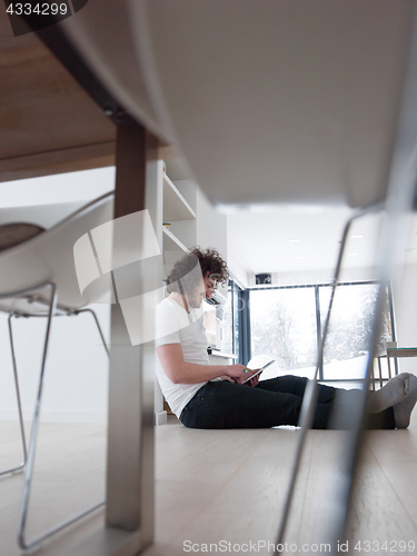 Image of young man using a tablet at home