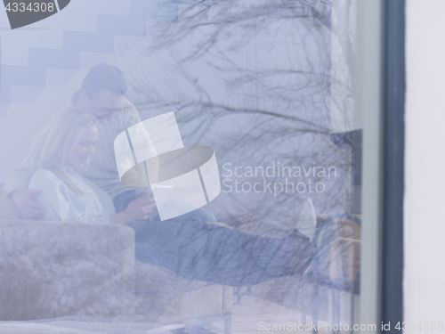 Image of Couple using digital tablet on cold winter day