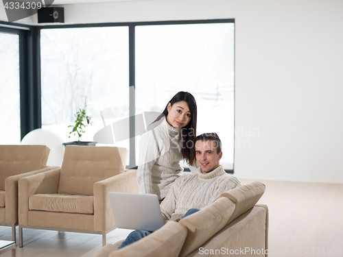 Image of multiethnic couple using laptop computers