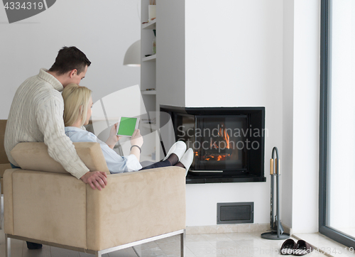 Image of Couple using digital tablet on cold winter day