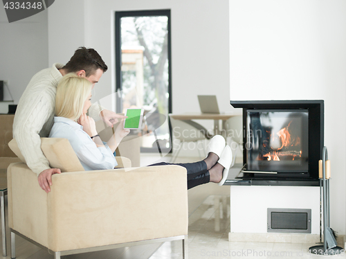 Image of Couple using digital tablet on cold winter day