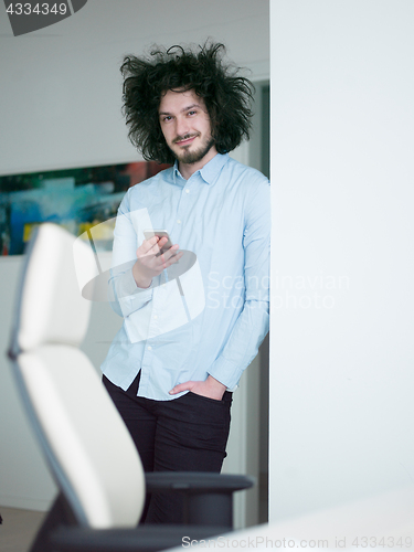 Image of man using a mobile phone  at home