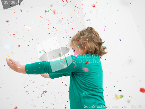 Image of kid blowing confetti