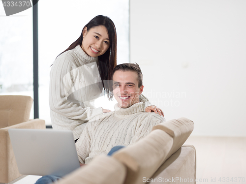 Image of multiethnic couple using laptop computers