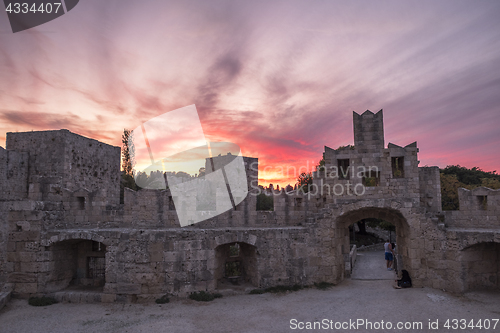 Image of The fortress wall in the harbor at sunset. Rhodes