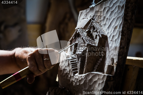 Image of Sculptor hands working wood