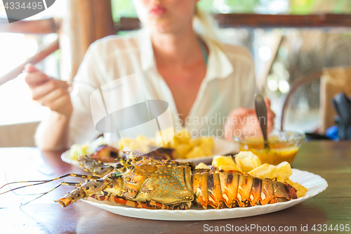 Image of Grilled lobster served with potatoes and coconut sauce.