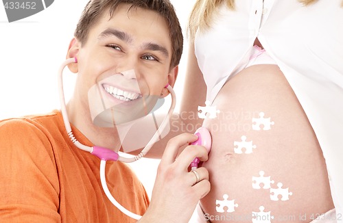 Image of puzzle of happy father playing doctor